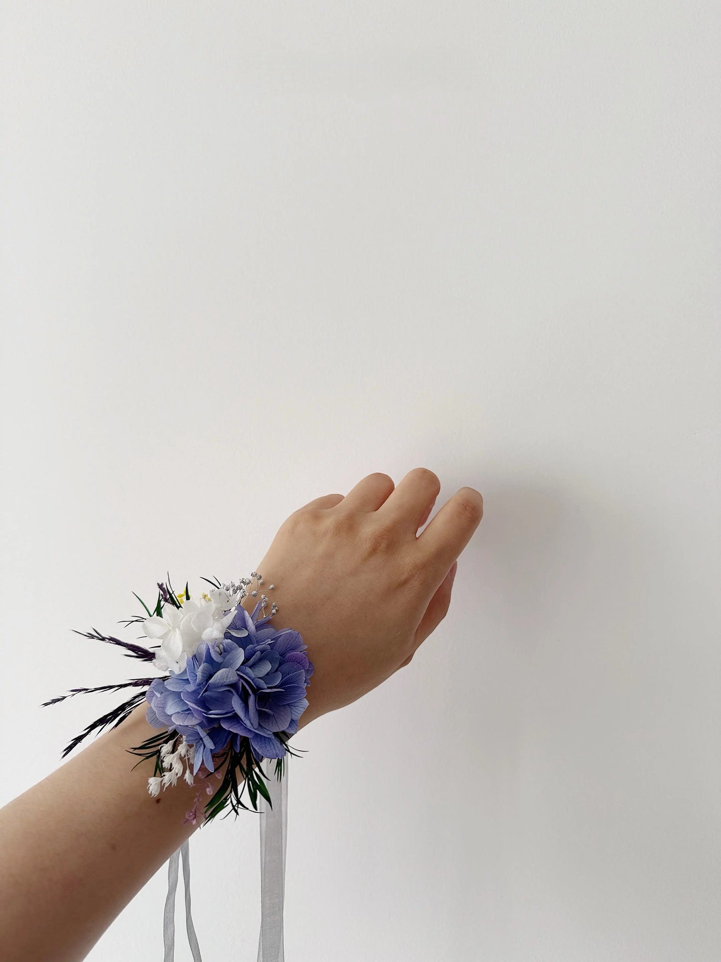 Purple preserved flower wrist corsage worn on hand for wedding accessories