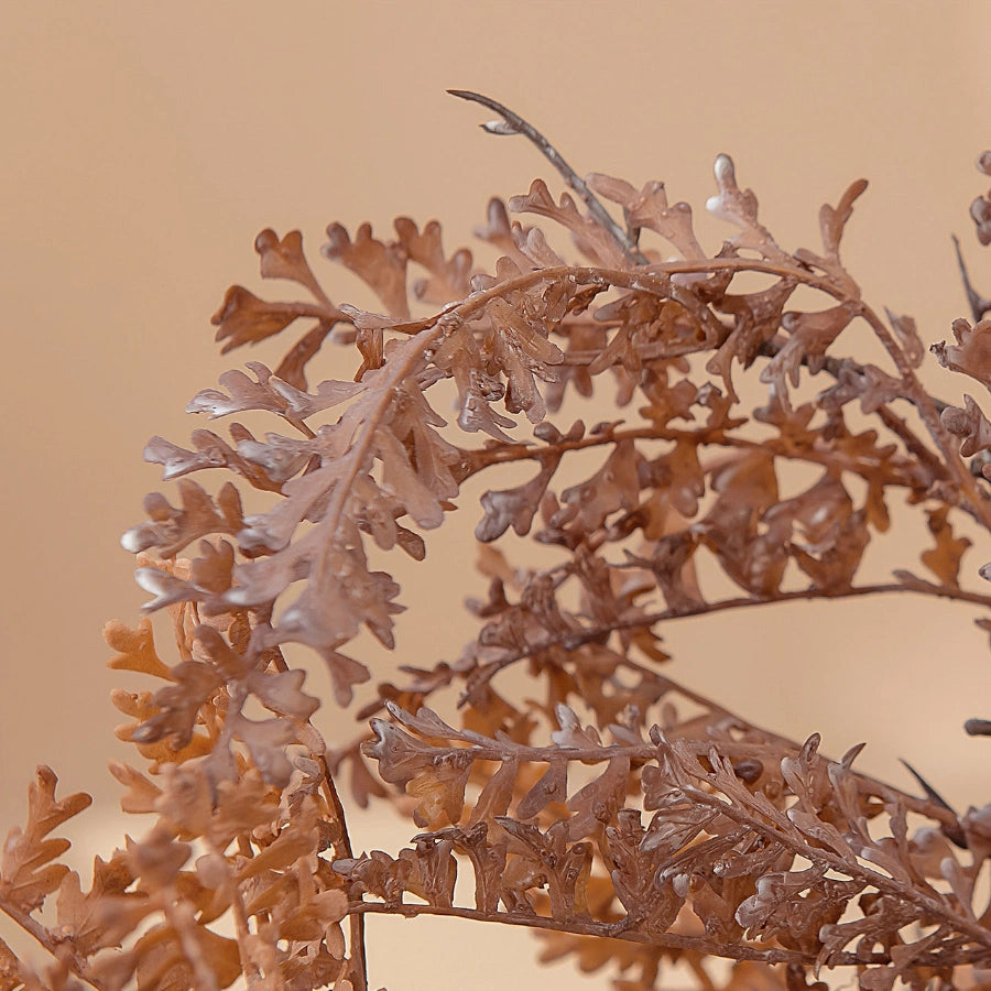 Detailed artificial dried-look faux fern leaves in warm brown beige tones for rustic floral arrangement