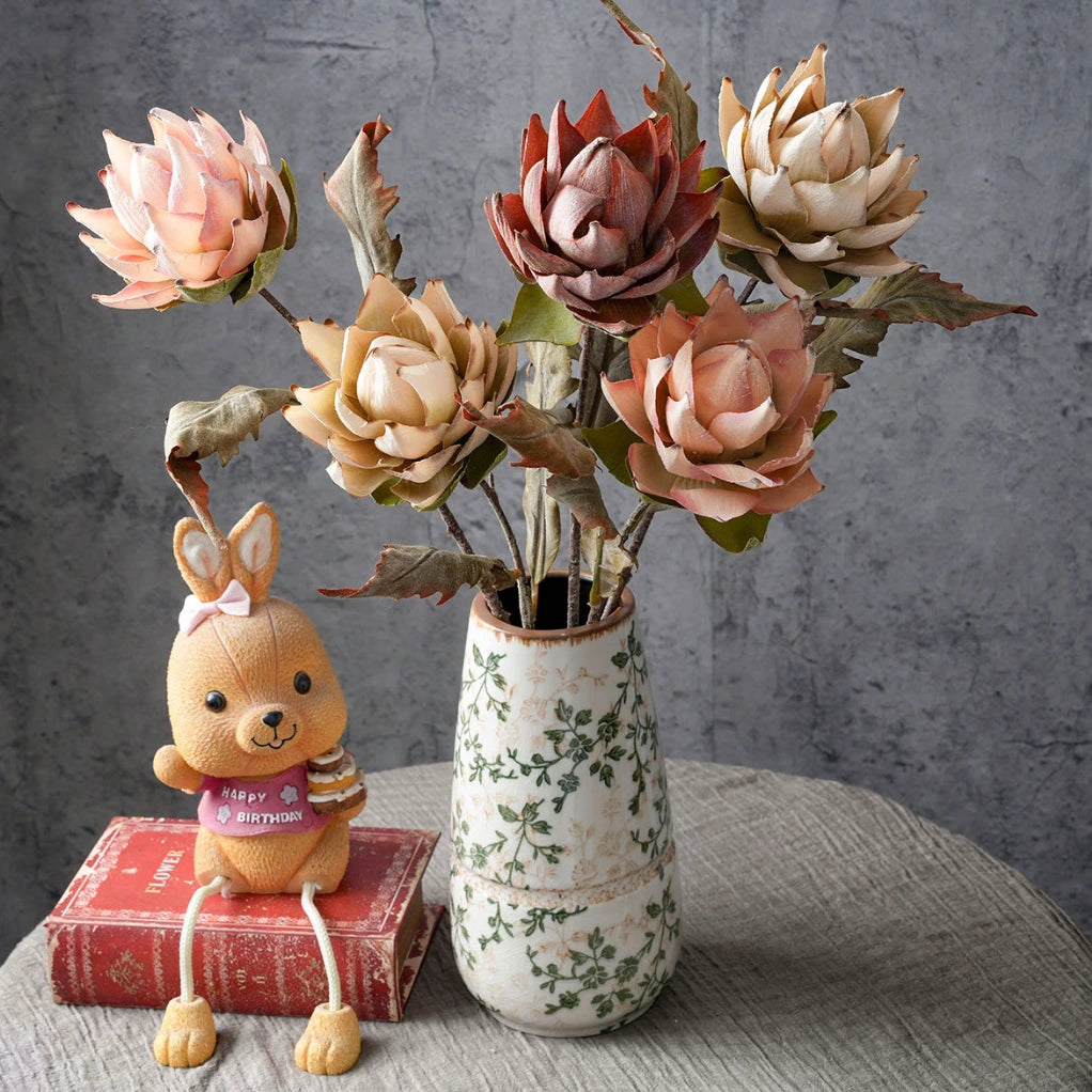 Mixed faux king protea flowers in decorative vase for vintage interior floral decoration
