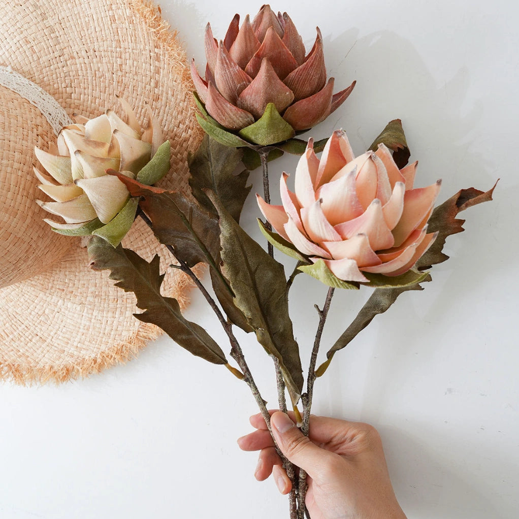 Handheld faux king protea bouquet with beige pink and orange flowers for interior styling