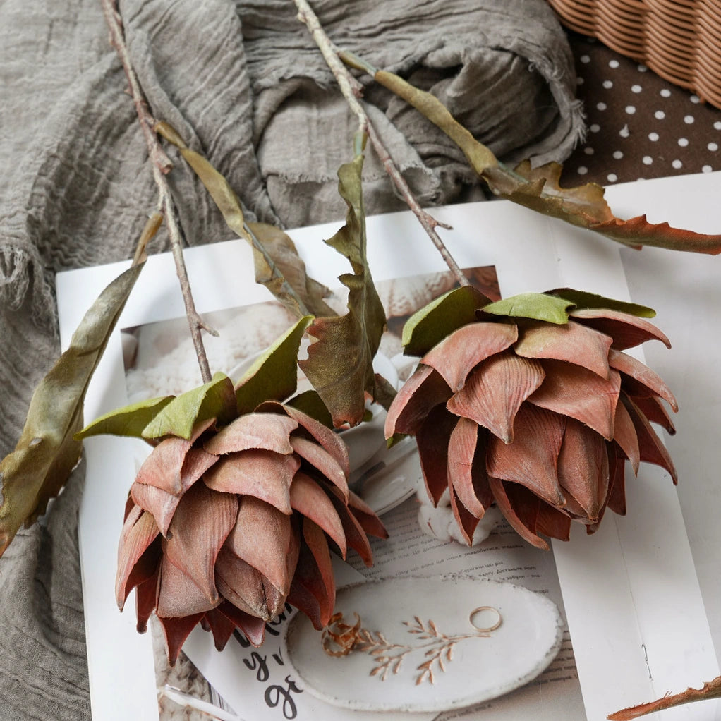 Vintage faux king protea stems in muted pink and beige tones for artistic floral styling