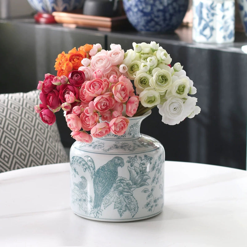 Artificial ranunculus in refined colors arranged in a vintage vase, timeless and decorative.