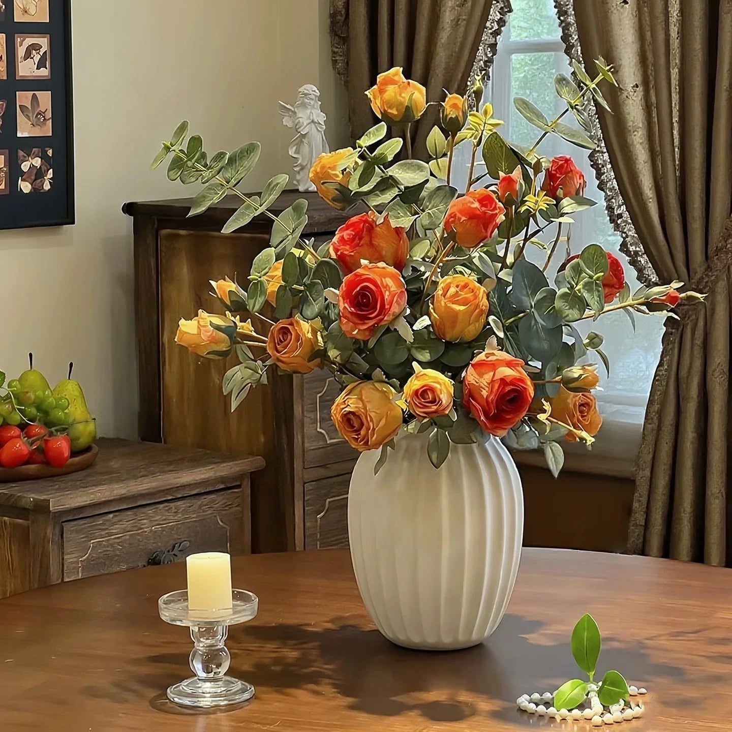Artificial rose bouquet in vase with warm orange tones for cozy home decor styling