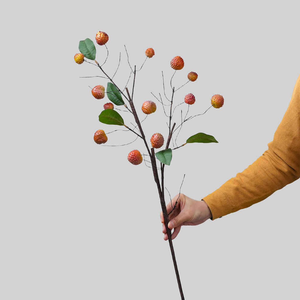 Single artificial lychee branch showing long stem and faux fruit clusters for vase styling