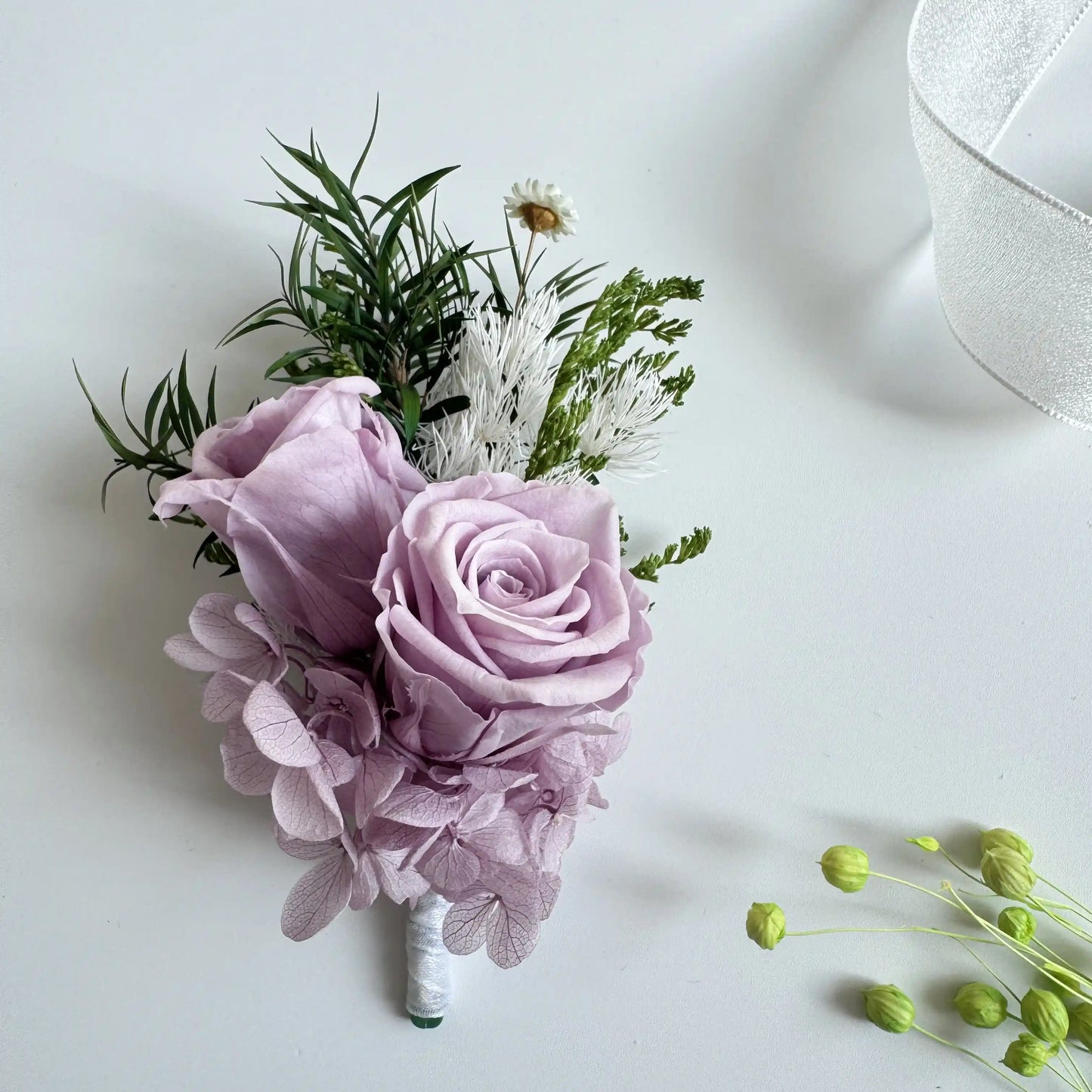 Lavender preserved rose double bloom wedding boutonniere with greenery