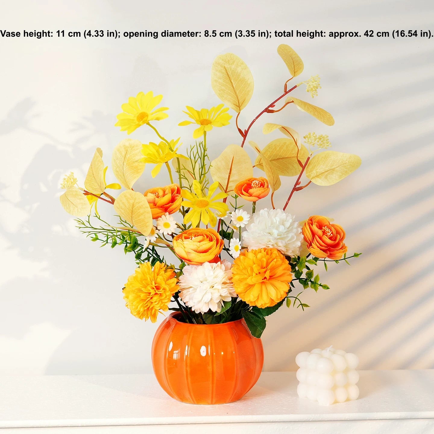Colorful artificial floral arrangement in orange vase for home tabletop decor