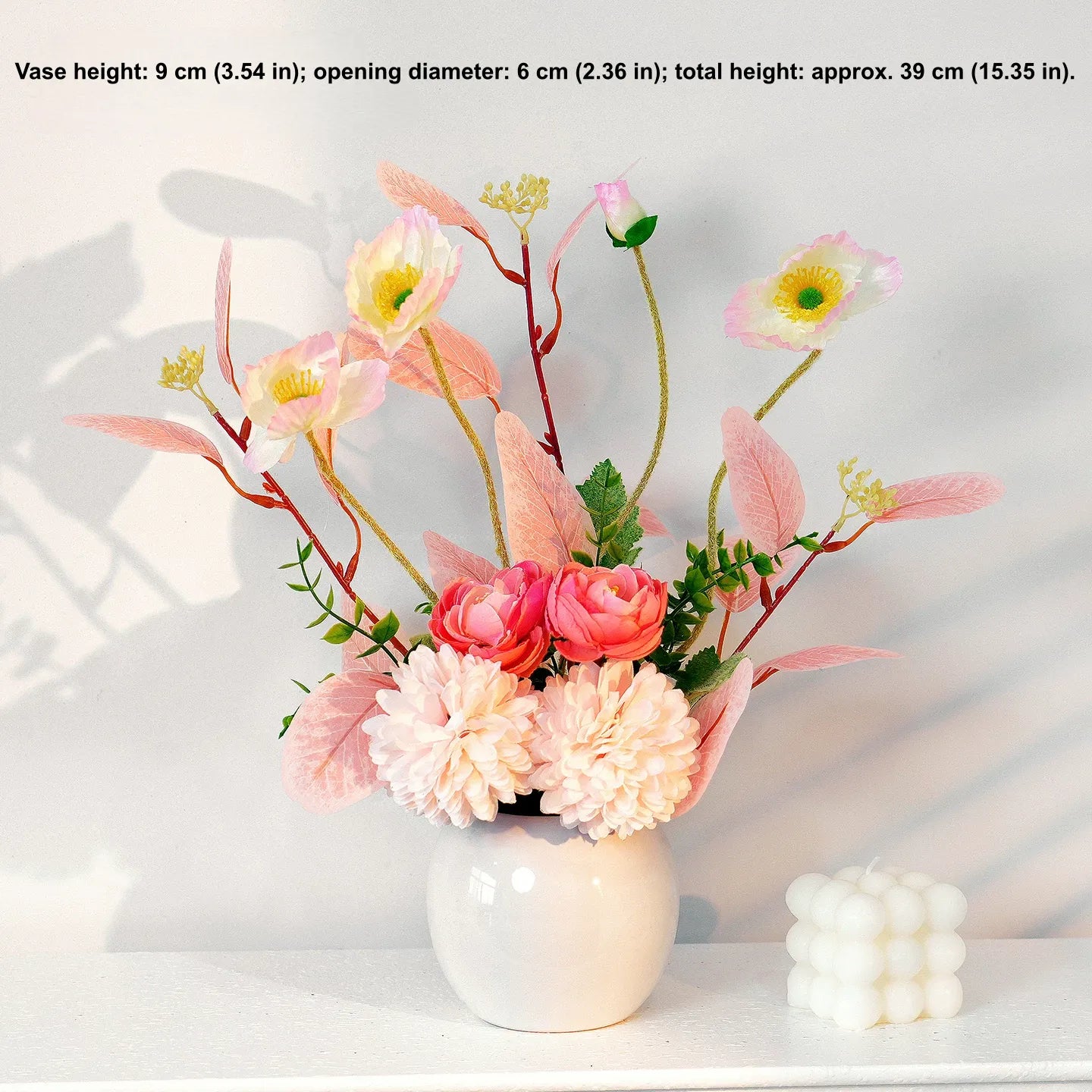 Pink and white artificial flower arrangement in white vase for home decor