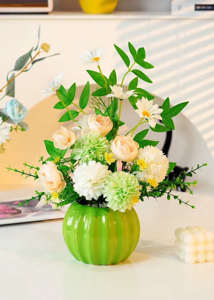 Green vase artificial floral arrangement with cream flowers for home decoration