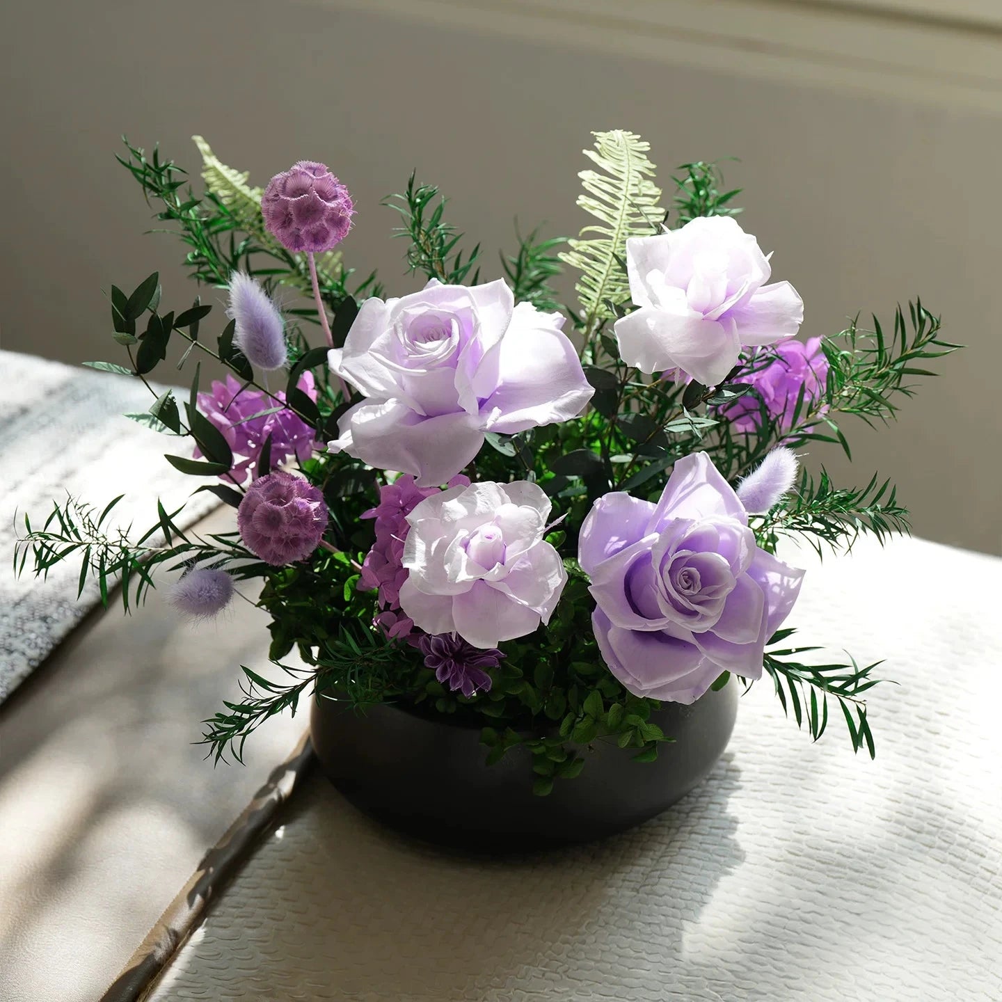 Purple preserved rose flower arrangement in black vase, luxury tabletop home decor