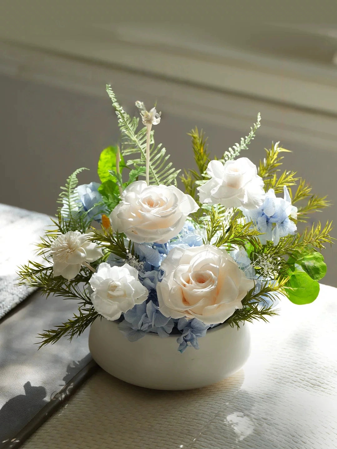 Champagne preserved rose floral arrangement with greenery, soft elegant desk decor