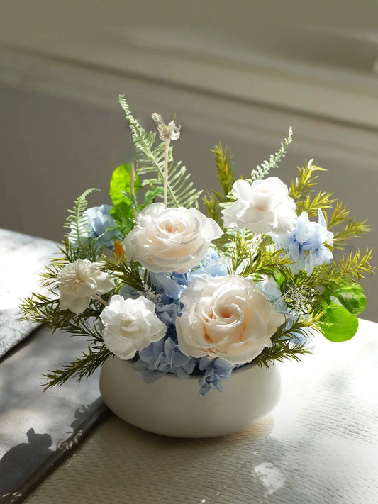 Champagne preserved rose floral arrangement with greenery, soft elegant desk decor