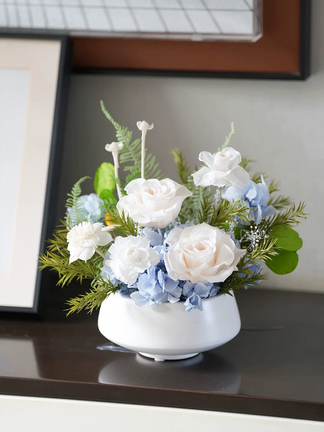 Preserved rose arrangement in white ceramic vase, minimalist home shelf decor