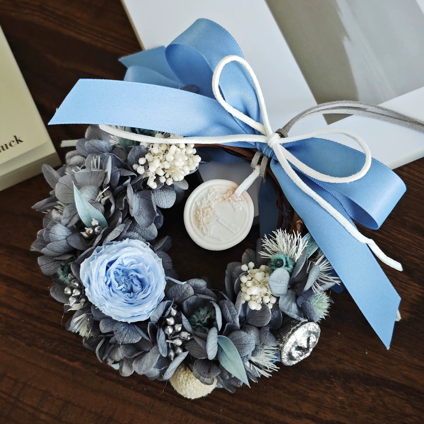 Dusty blue preserved flower wreath with blue ribbon for elegant home decor