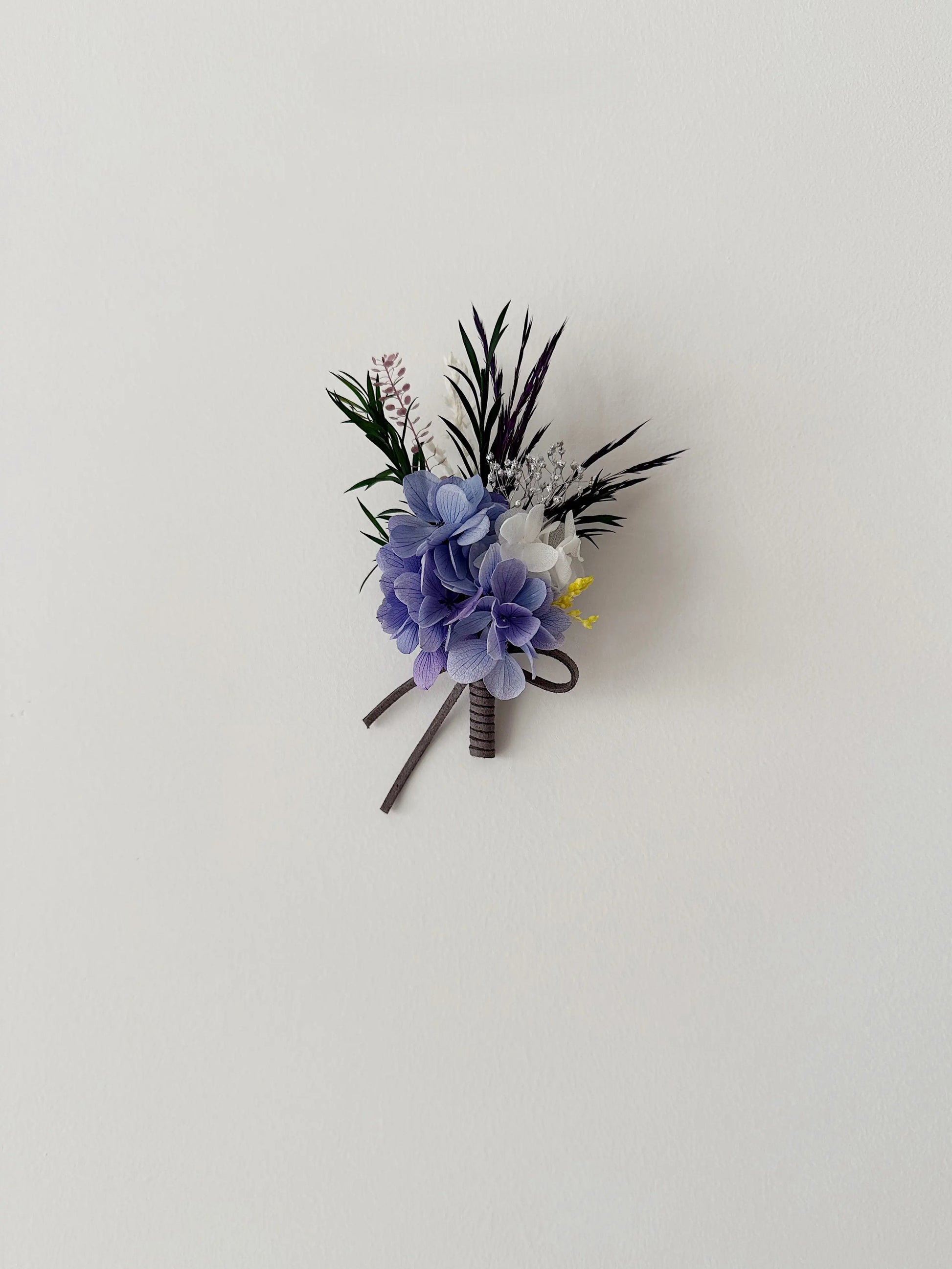 Purple preserved flower boutonniere with hydrangea for wedding suit decor
