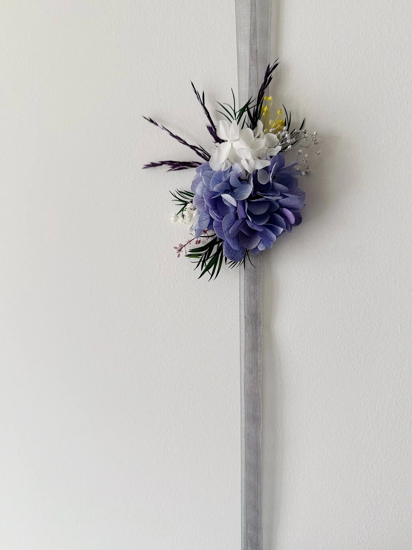 Elegant purple wrist corsage with preserved hydrangea flowers for bridal wedding