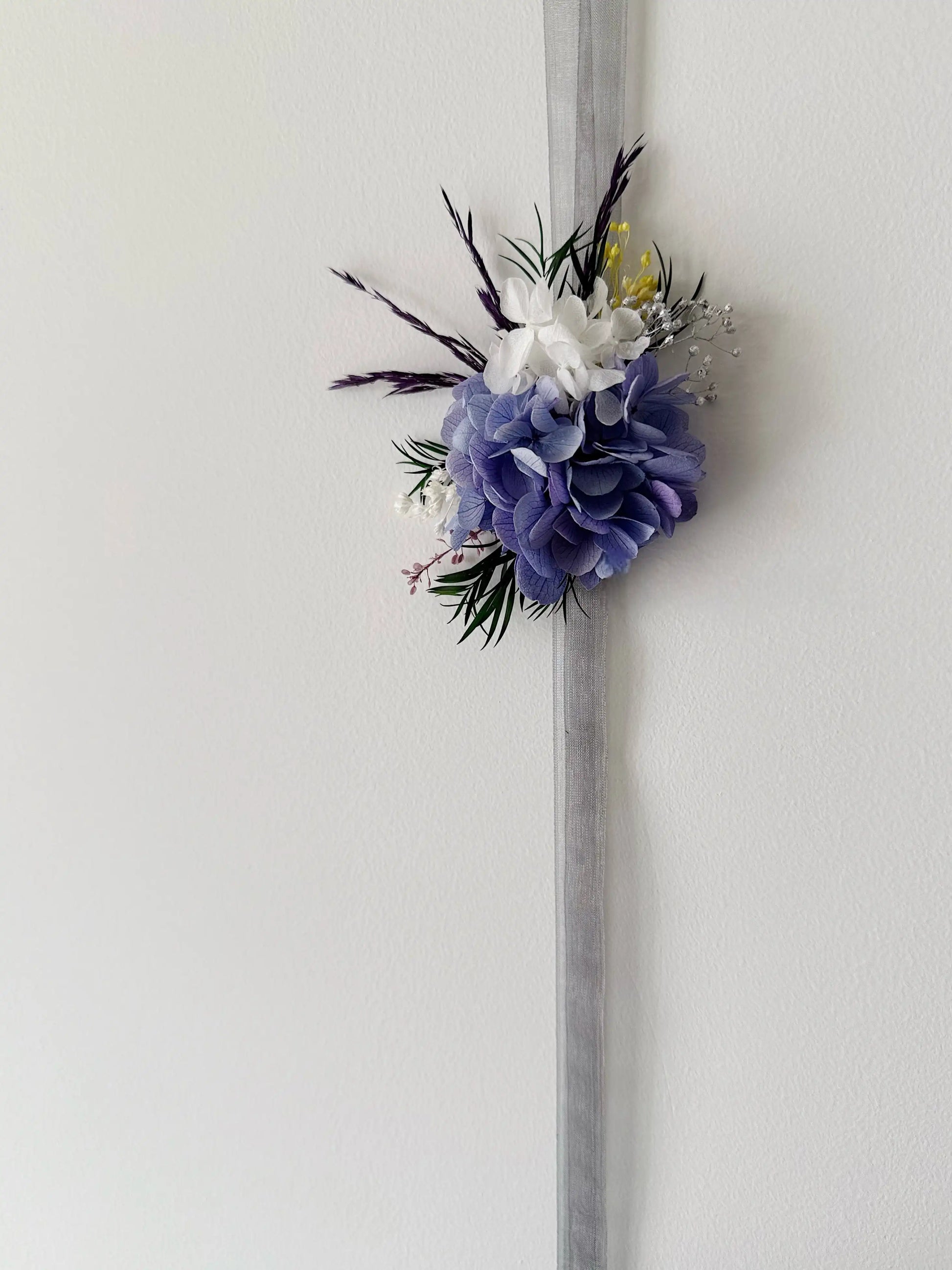 Elegant purple wrist corsage with preserved hydrangea flowers for bridal wedding