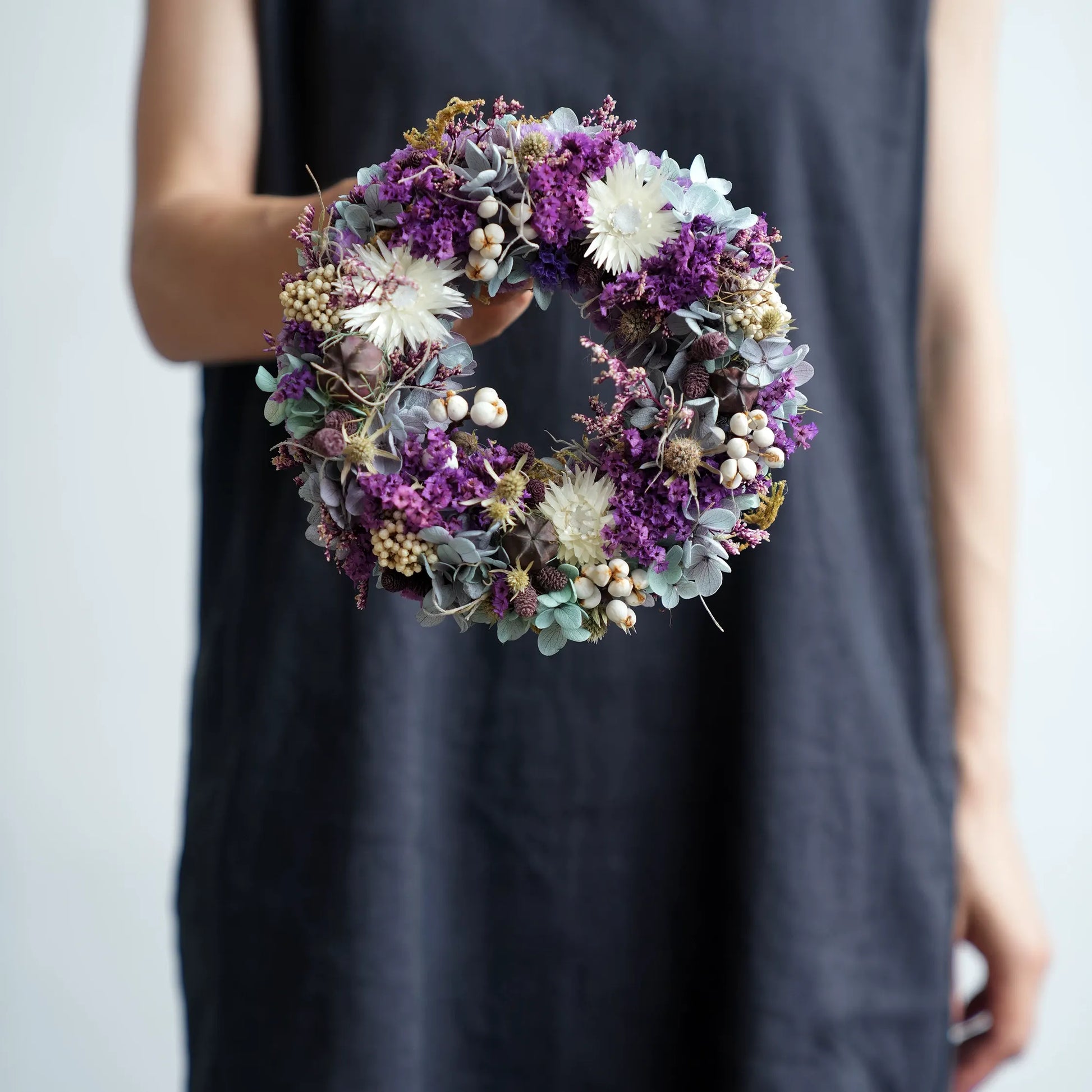 Purple preserved flower wreath for front door, elegant floral home decor for entryway or dining table.