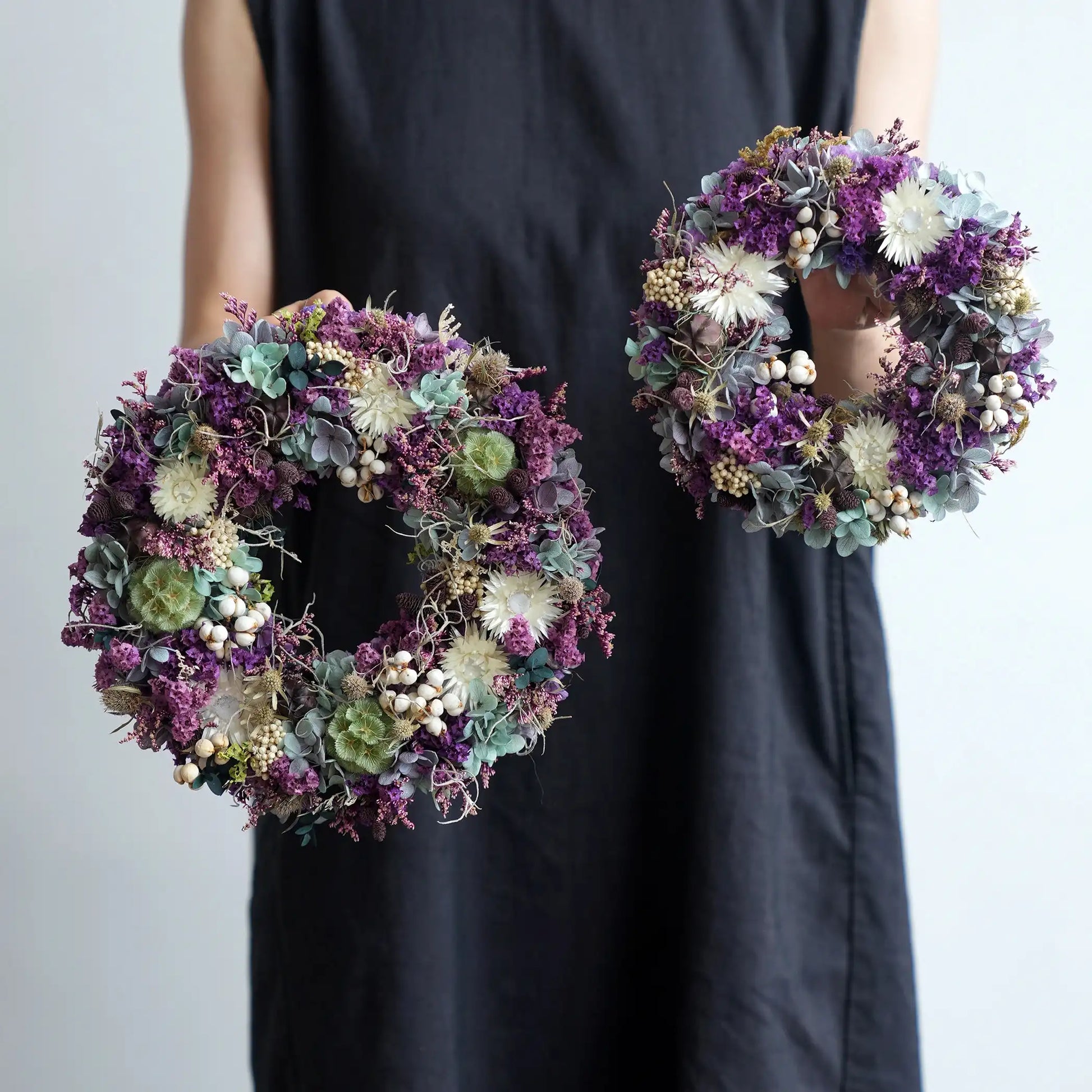 Decorative purple preserved flower wreath for front door, wall display, or dining table centerpiece.