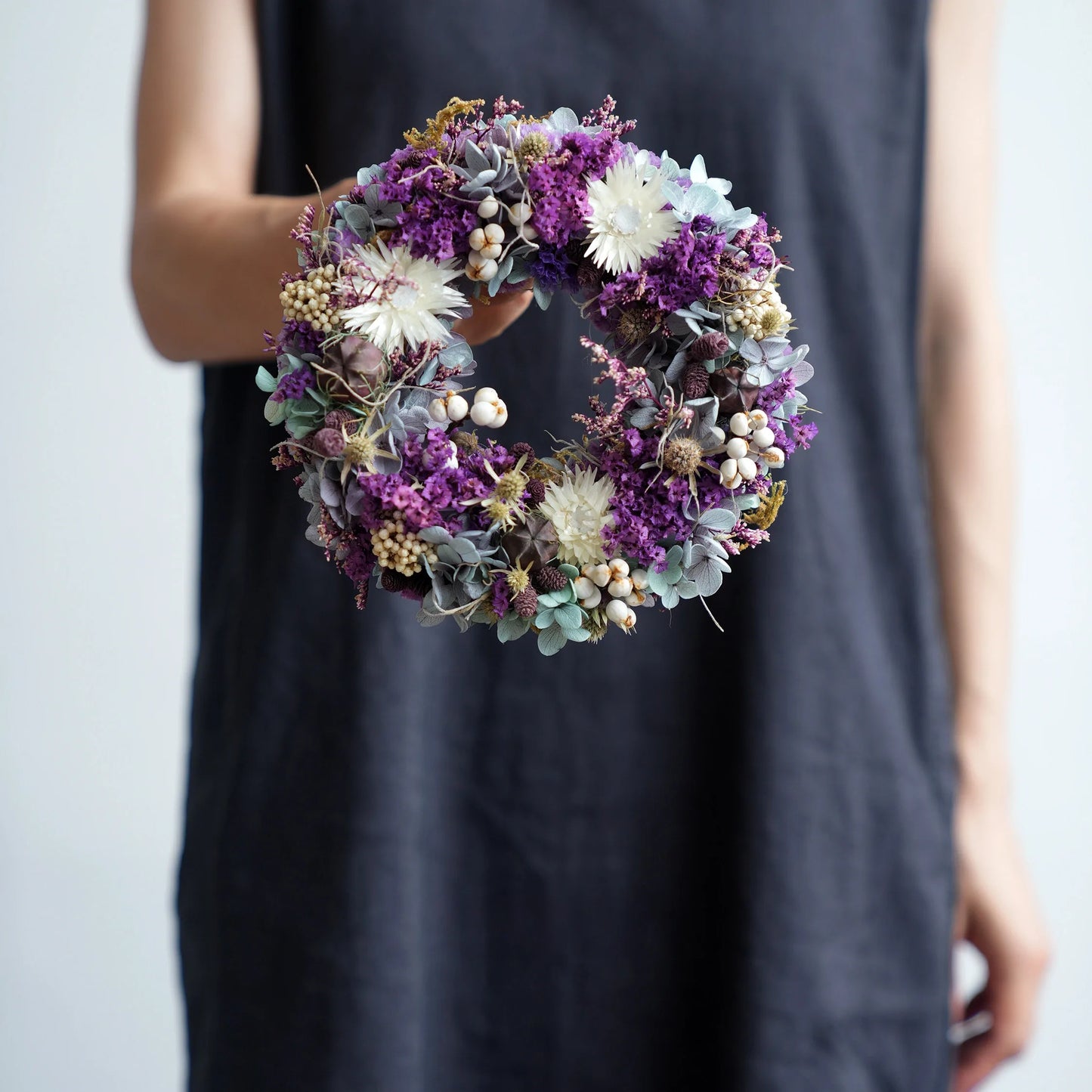 Beautiful purple preserved floral wreath for entryway door hanging and elegant home decoration.