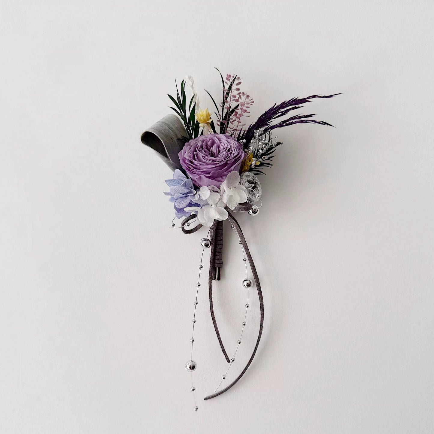 Purple preserved rose boutonniere with ribbon for groom wedding accessory