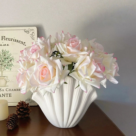 White and pink artificial rose bouquet in sculptural vase for home decor