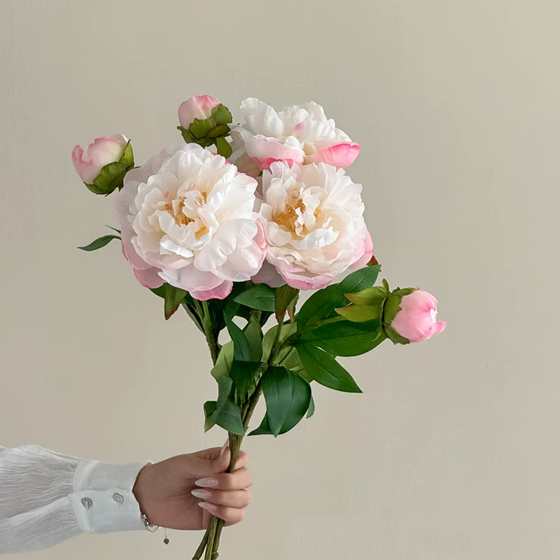 Blush pink and white peony artificial flower bouquet held by hand